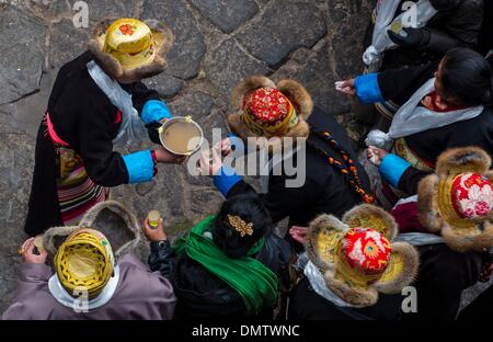 Lhasa, Tibet. 17th Dec, 2013. People drink wine to celebrate the Palden Lhamo Festival at the Jokhang Temple in Lhasa, capital of southwest China's Tibet Autonomous Region, Dec. 17, 2013. The Palden Lhamo Festival, which falls on the 15th day of the 10th month of the Tibetan calender, is celebrated by the female followers of Tibetan Buddhism to pray for a satisfactory marriage each year. Credit:  Purbu Zhaxi/Xinhua/Alamy Live News Stock Photo