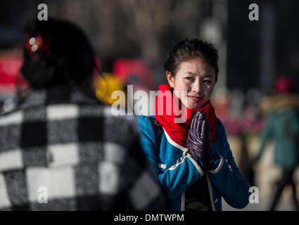 Lhasa, Tibet. 17th Dec, 2013. A girl of the Tibetan ethnic group comes to the Jokhang Temple to pay homage to Palden Lhamo, a goddess in the Tibetan Buddhism, in Lhasa, capital of southwest China's Tibet Autonomous Region, Dec. 17, 2013. The Palden Lhamo festival, which falls on the 15th day of the 10th month of the Tibetan Calender, is celebrated by the female followers of Tibetan Buddhism to pray for a satisfactory marriage each year. Credit:  Purbu Zhaxi/Xinhua/Alamy Live News Stock Photo