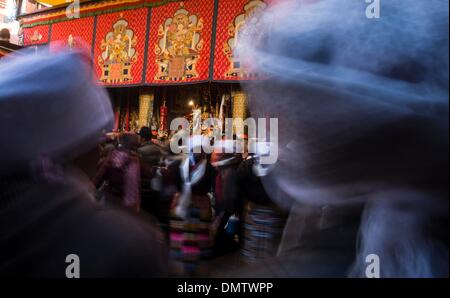 Lhasa, Tibet. 17th Dec, 2013. People dance the Guozhuang, a bonfire dance of the Tibetan ethnic group, to celebrate the Palden Lhamo Festival at the Jokhang Temple in Lhasa, capital of southwest China's Tibet Autonomous Region, Dec. 17, 2013. The Palden Lhamo Festival, which falls on the 15th day of the 10th month of the Tibetan Calender, is celebrated by the female followers of Tibetan Buddhism to pray for a satisfactory marriage each year. Credit:  Purbu Zhaxi/Xinhua/Alamy Live News Stock Photo