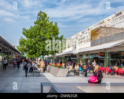 The Brunswick Centre outdoor space with benches, trees and alfresco dining - Grade ll listed residential & shopping centre IN Bloomsbury,Camden,London Stock Photo