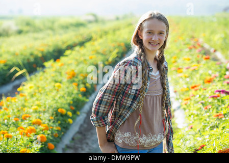 Summer on an organic farm. A young girl in a field of flowers. Stock Photo