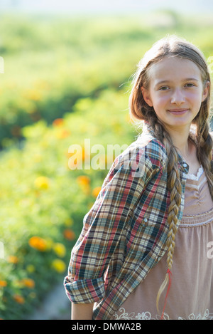 Summer on an organic farm. A young girl in a field of flowers. Stock Photo