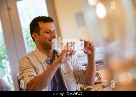 A small holding up a small smart phone. Stock Photo