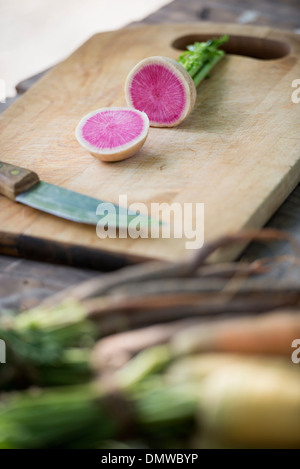 Sorting and chopping freshly picked summer vegetables and fruits. Stock Photo