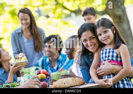 A summer party outdoors. Adults and children smiling and looking at  camera. Stock Photo