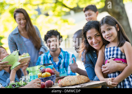 A summer party outdoors. Adults and children smiling and looking at  camera. Stock Photo