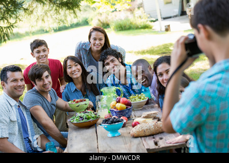 A summer party outdoors. Adults and children posing for a photograph. Stock Photo