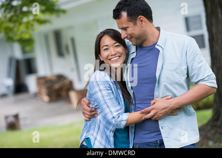 A couple  with arms around each or. Stock Photo