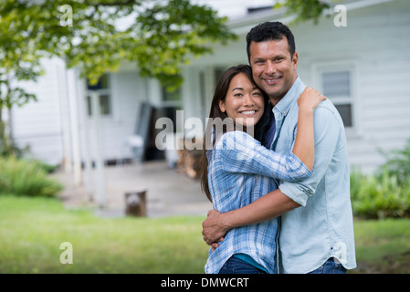 A couple  with arms around each or. Stock Photo