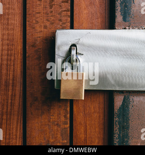 Close up of a wooden doorway with a padlock. Stock Photo