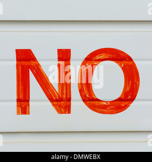 A large NO sign in red paint on a garage door indicating No Parking. Stock Photo