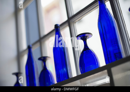 A cafe interior. Bright blue glassware on empty tables. Stock Photo