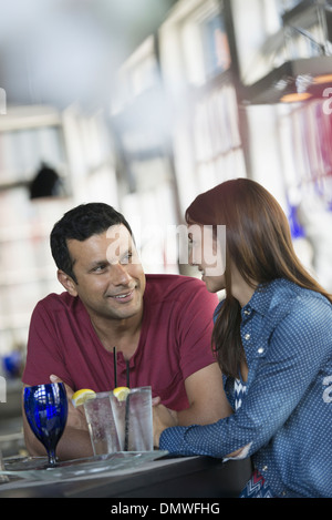 A cafe interior. A man and woman seated at a table. Stock Photo