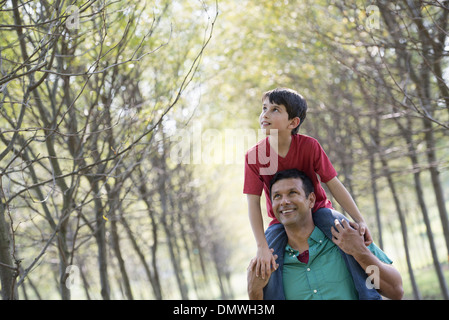 A boy having a piggyback riding on a man's shoulders. Stock Photo