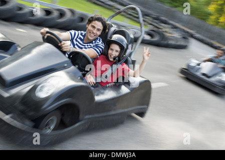 Boys and men go-karting on a track. Stock Photo