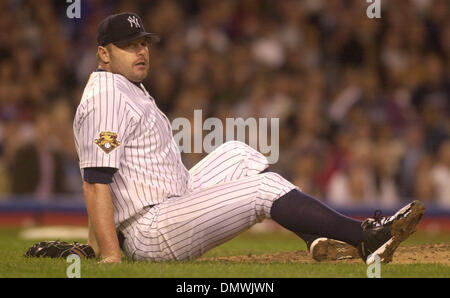 Oct 15, 2001; Bronx, NY, USA; Yankees' pitcher Roger Clemens, #22, watches first base after a ball hit by Oakland A's Johnny Damon, #8, knocks him down in the 3rd inning of game 5 of the American Division playoffs on Monday, October 15, 2001 at Yankee Stadium in Bronx, New York. Damon would be thrown out at first. Stock Photo