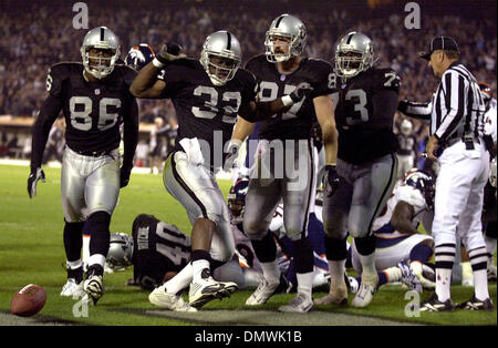 Oakland, California, USA. 16th Nov, 2003. Oakland Raiders full back Zack  Crockett (32) runs for a touchdown with Minnesota Vikings defensive back  Corey Chavous (21) on Sunday, November 16, 2003, in Oakland