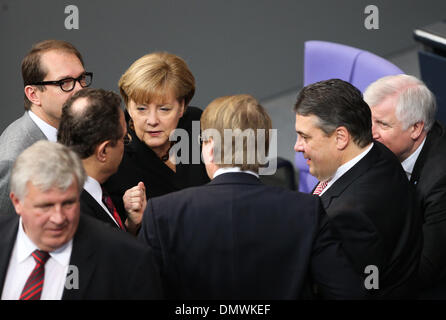 Berlin, Germany. 17th Dec, 2013. German Chancellor Angela Merkel (4th L) talks to other German politicians during the meeting of Bundestag, Germany's lower house of parliament, in Berlin, Germany on Dec. 17, 2013. Angela Merkel was reelected in a vote in the lower house of parliament on Tuesday for a third term, and her coalition government will be sworn into office to rule Europe's biggest economy for the next four years. Credit:  Zhang Fan/Xinhua/Alamy Live News Stock Photo