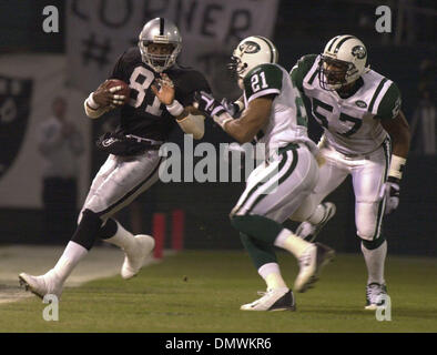 Jan 19, 2002; Foxboro, MA, USA; Oakland Raiders quarterback Rich Gannon,  #12, holds his head in dejection after teammate Jerry Rice, #80, drops a  pass in the 4th qt. during their AFC