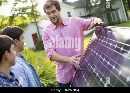 Two people walking towards a farmhouse garden. Stock Photo