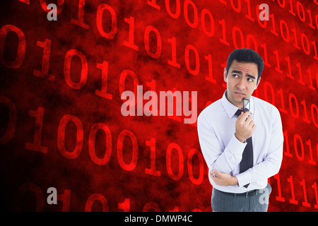 Composite image of thinking businessman holding glasses Stock Photo