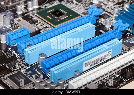 Computer motherboard components with empty slots for cards Stock Photo