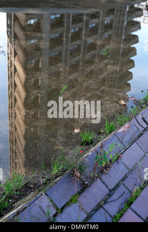 Barbican Estate Tower building housing flats reflected upside down in puddle of water London England UK  KATHY DEWITT Stock Photo