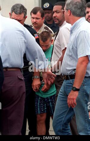 June 4, 1993 - West Memphis, AR, U.S. - June 4, 1993 - Jessie Lloyd Misskelley Jr.  is led from the West Memphis police station after arraignment Friday afternoon in the murders of three West Memphis boys.  West Memphis Municipal Court, Judge William P. Rainey appointed attorneys for the defendants and bound them over to Crittenden County Circuit Court for a hearing on Monday. Over Stock Photo