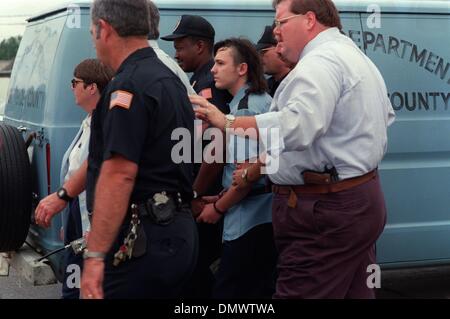 June 4, 1993 - West Memphis, AR, U.S. - June 4, 1993 - Michael Wayne ''Damien''  Echols is led from the West Memphis, Ark. police station after arraignment Friday afternoon in the murders of  eight-year-olds Christopher Byers, Michael Moore and Steve Branch whose bodies were found May 6. As the closely guarded suspects Echols, Jessie Lloyd Misskelley Jr. and Charles Jason Baldwin w Stock Photo