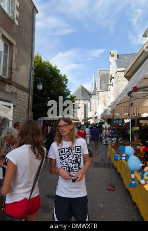 Guerande market, with stalls and shoppers with young man wearing tee shirt with QR code printed on it Stock Photo