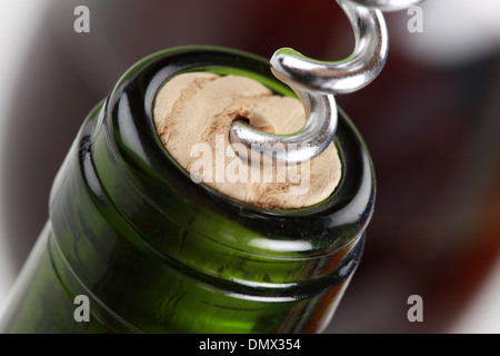 Opening a wine bottle with a corkscrew Stock Photo