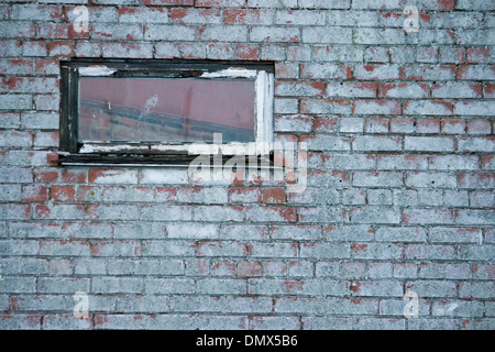 Rotten window frame in brick wall Stock Photo