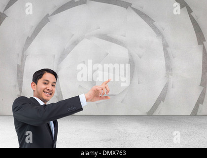 Composite image of smiling asian businessman pointing Stock Photo