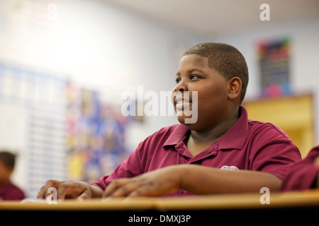Middle school aged African American boy paying attention in class. Stock Photo