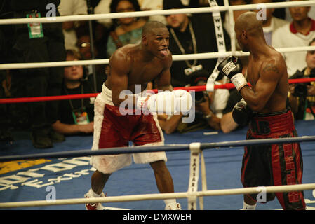 Apr 08, 2006; Las Vegas, NV, USA; FLOYD MAYWEATHER JR. vs ZAB JUDAH IBF Welterweight Fight. When JUDAH Punched MAYWEATHER below the belt  ROGER MAYWEATHER trainer & Uncle jumped into the ring & went after ZAB JUDAH. FLOYD MAYWEATHER JR ( L) taunts by sticking his tongue out at ZAB JUDAH (R) red & black trunks. Nevada athletic Chief Inspector TONY LATO  & inspectors in burgandy jack Stock Photo