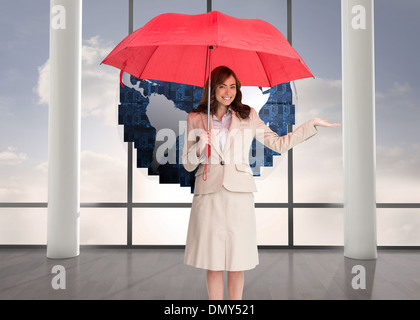 Composite image of happy businesswoman holding umbrella Stock Photo