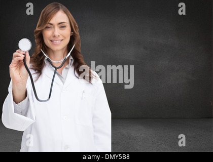 Composite image of happy doctor using stethoscope Stock Photo
