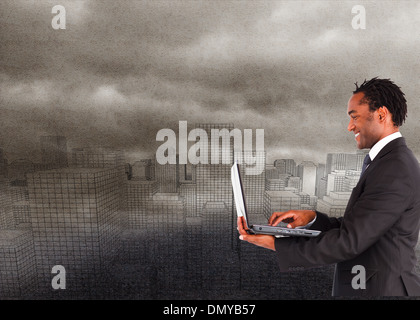 Composite image of businessman working on laptop Stock Photo