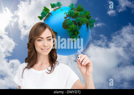 Composite image of smiling businesswoman holding marker Stock Photo