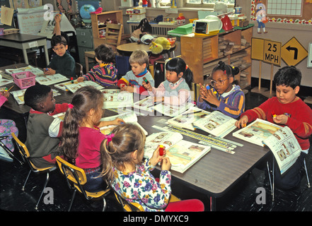 Kindergarteners using work books in a public school in Brooklyn, New York one of the more ethnically diverse areas on earth. Stock Photo