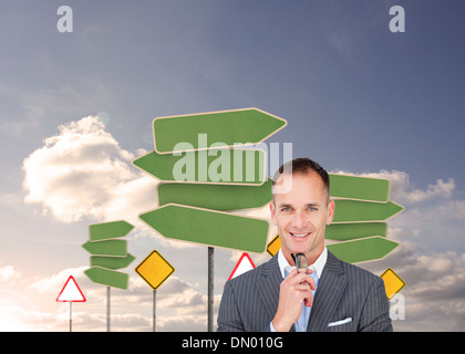 Composite image of smiling businessman holding glasses Stock Photo