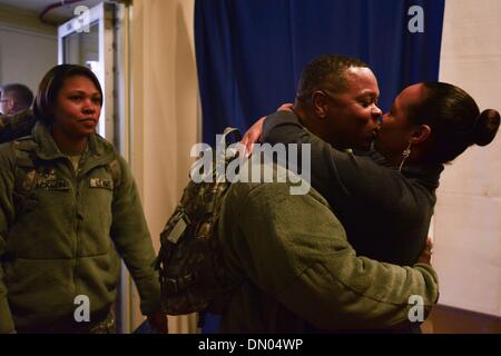 Washington, District of Columbia, US, USA. 17th Dec, 2013. Command Sgt. JUAN MITCHELL is welcomed with a kiss and a hug from his wife SHERRY MITCHELL at the DC Armory during a homecoming ceremony for nearly 50 soldiers from D.C.'s Army National Guard 372nd Military Police Battalion. The soldiers were returning from a 10-month deployment to Guantanamo Bay, Cuba, in support of Operation Enduring Freedom. Many of the servicemen have deployed at least once previously, and nine work as police officers while not on military duty. Credit:  Miguel Juarez Lugo/ZUMAPRESS.com/Alamy Live News Stock Photo