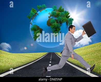 Composite image of businessman running with a suitcase Stock Photo