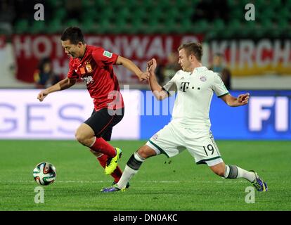 Agadir, Morocco. 17th Dec, 2013. Guangzhou Evergrande's Huang Bowen (L) vies for the ball during the match between Guangzhou Evergrande and Bayern Munich at the FIFA's 2013 Club World Cup soccer match in Agadir, Morocco, Dec. 17, 2013. Bayern Munich won the match 3-0. Credit:  Liu Dawei/Xinhua/Alamy Live News Stock Photo