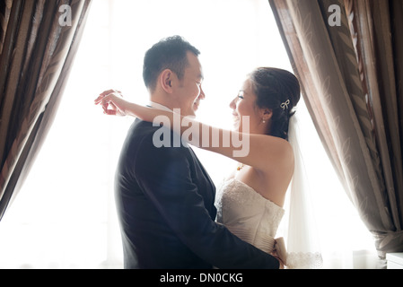 Romantic Asian Chinese wedding couple. Bride and groom dancing on wedding day. Stock Photo