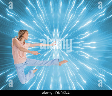 Composite image of woman doing dance pose Stock Photo