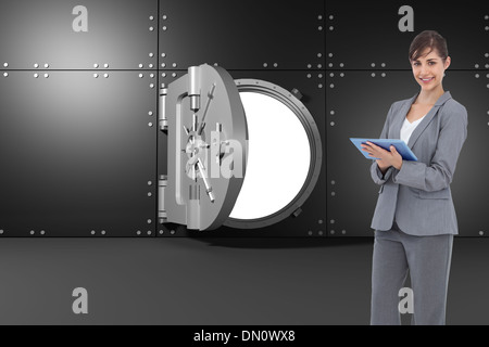 Composite image of smiling businesswoman with tablet computer Stock Photo