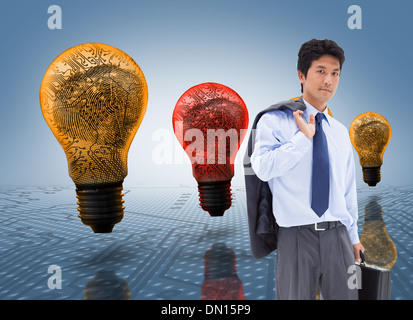 Composite image of portrait of a businessman holding a briefcase and his jacket on his shoulder Stock Photo