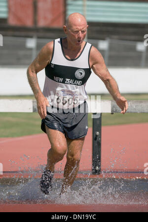 Jan 19, 2006; Christchurch, NEW ZEALAND; DAVE EASTMOND, 67, of New Zealand splashes through a water pit in the 2000m steeplechase at Oceania Association of Master Athletes 13th Track and Field ChampIonships. Eastmond finished third in the men's 65-69 age bracket.  Mandatory Credit: Photo by P.J. Heller/ZUMA Press. (©) Copyright 2006 by P.J. Heller Stock Photo