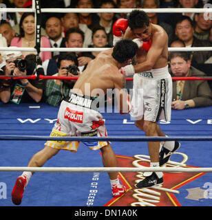 Jan 21, 2006; Las Vegas, NV, USA; MANNY PACQUIAO of the Philippines, right, connects with a left to ERIK MORALES of Mexico, during their super featherweight boxing match Saturday night. Pacquiao won when the fight was stopped in the 10th round. Mandatory Credit: Photo by J.P. Yim/ZUMA Press. (©) Copyright 2006 by J. P. Yim